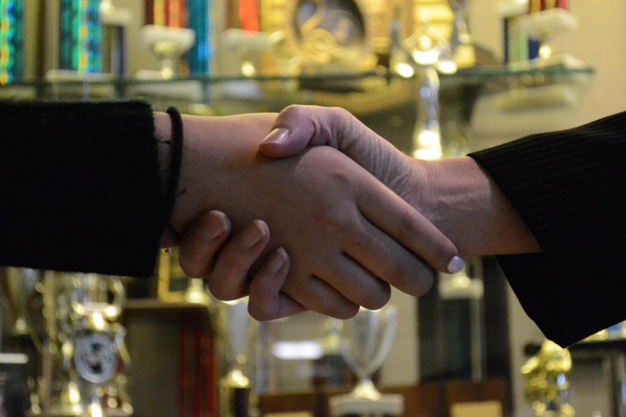 Superintendent Dr. Christy Sefcik Shaking hands with student who earned scholarship from raised money from the Grant Gala.