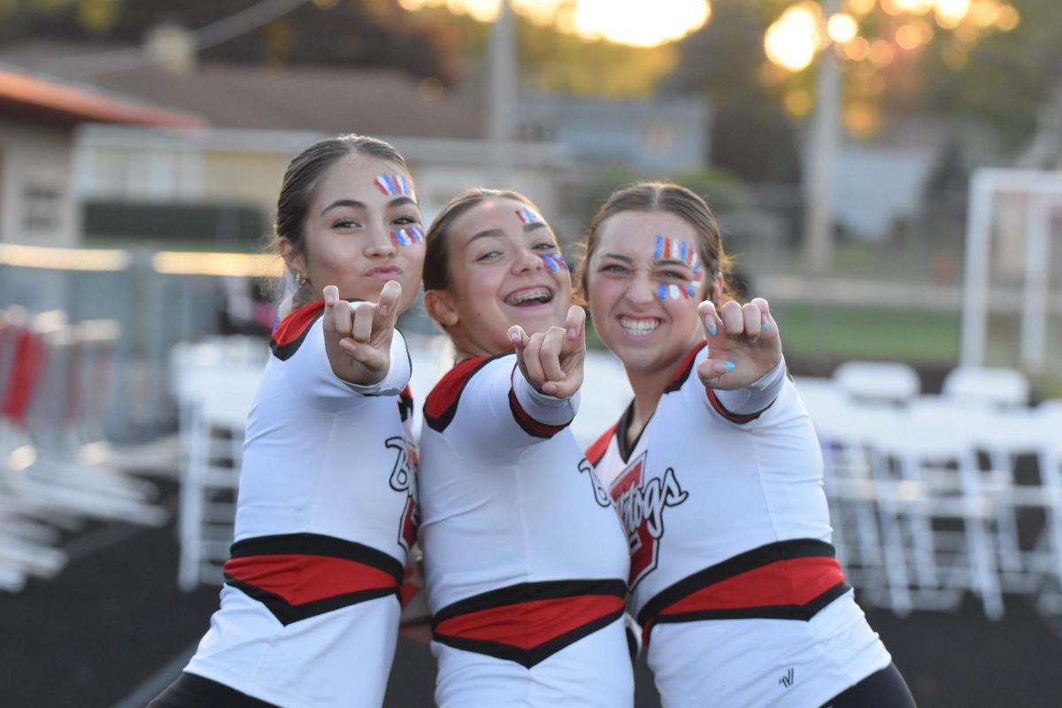 Grant dancers: Madelyn Escobado, Hannah Levine, and Julia DallaValle on sidelines of USA football game. 