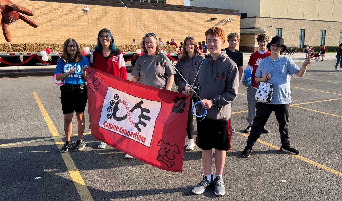 Alysse Sutschek, Carrera Frazier-Ortegel, Cheryl Trevithick,and Austin Hammond holding the K9 Connection sign right before walking through the homecoming parade 